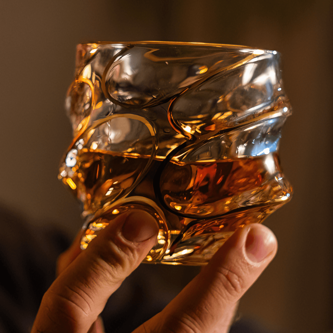 a person holding a japanese whiskey glass