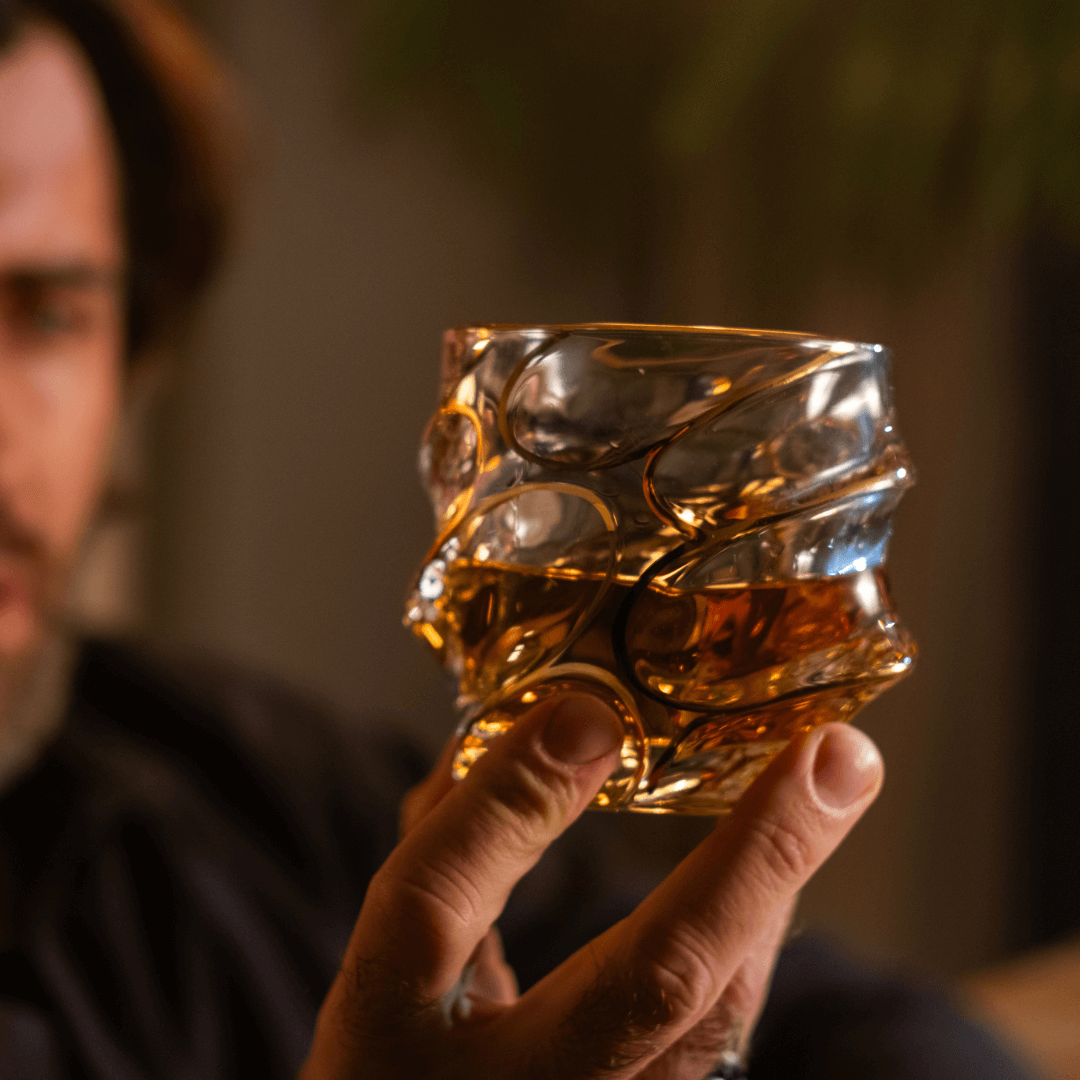 a person holding a japanese whiskey glass