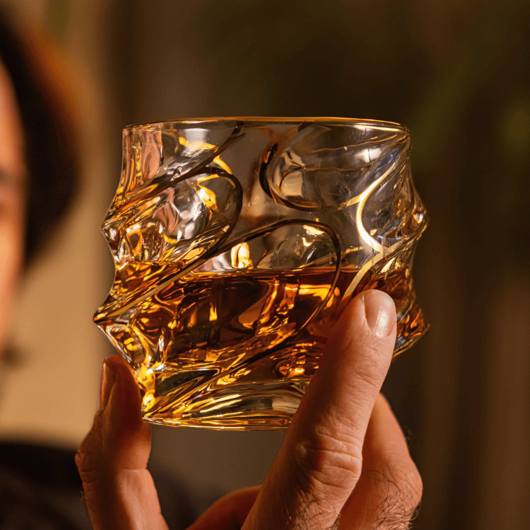 a person holding a japanese whiskey glass