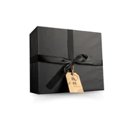 A black gift box with a tied ribbon and a brown tag attached.