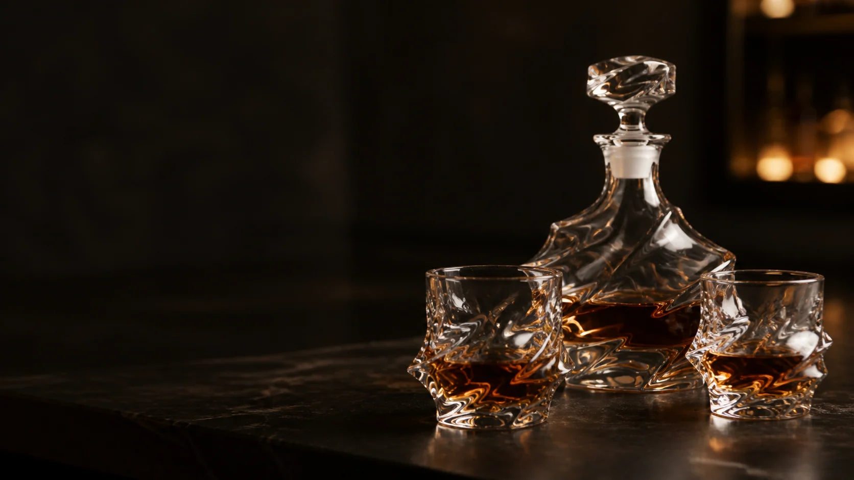 Storm whisky glasses and a matching crystal decanter on a dark bar