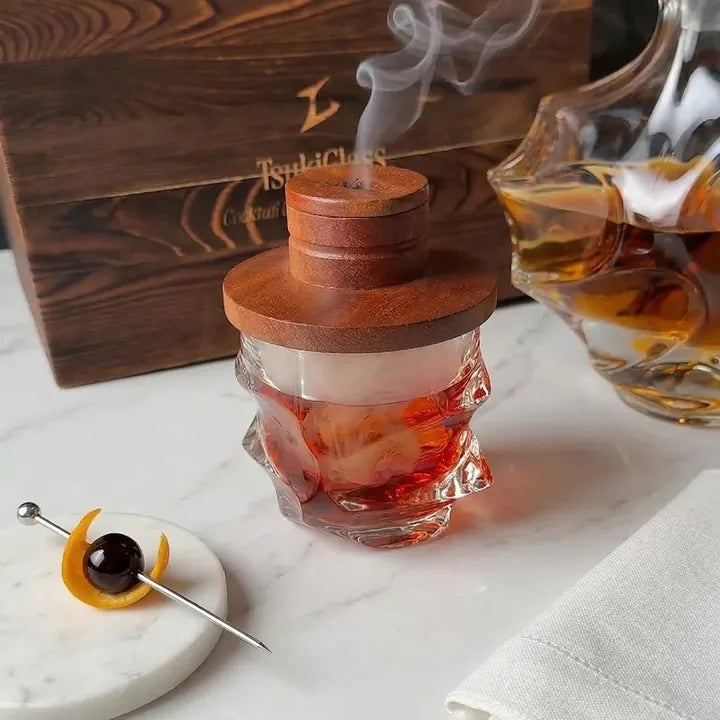 Smoked cocktail under the Tsuki smoker lid next to the wooden gift box
